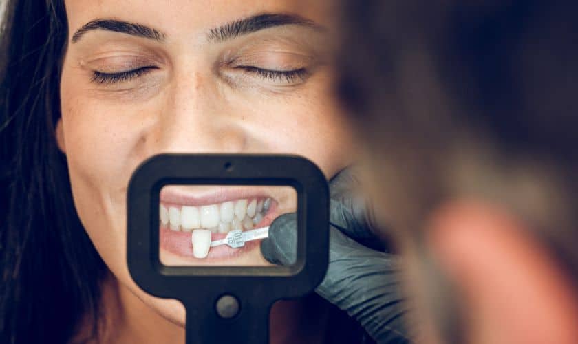 Woman receiving thermal imaging examination of teeth during dental consultation at Dakota Smiles.
